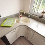 Acrylic countertop in the kitchen with corner sink