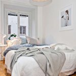 White double bed in the interior of a narrow bedroom