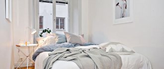 White double bed in the interior of a narrow bedroom