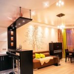 Black bar counter in the kitchen-living room of a city apartment