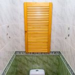 Wooden blinds in the toilet of a small apartment