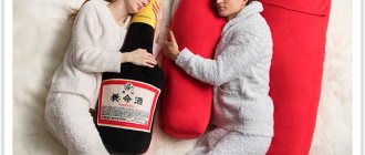 A girl and a boy sleep with pillows hugging in the shape of bottles