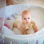 Newborn baby in a round crib