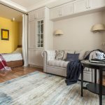 Yellow niche with a bed in an apartment of 38 square meters